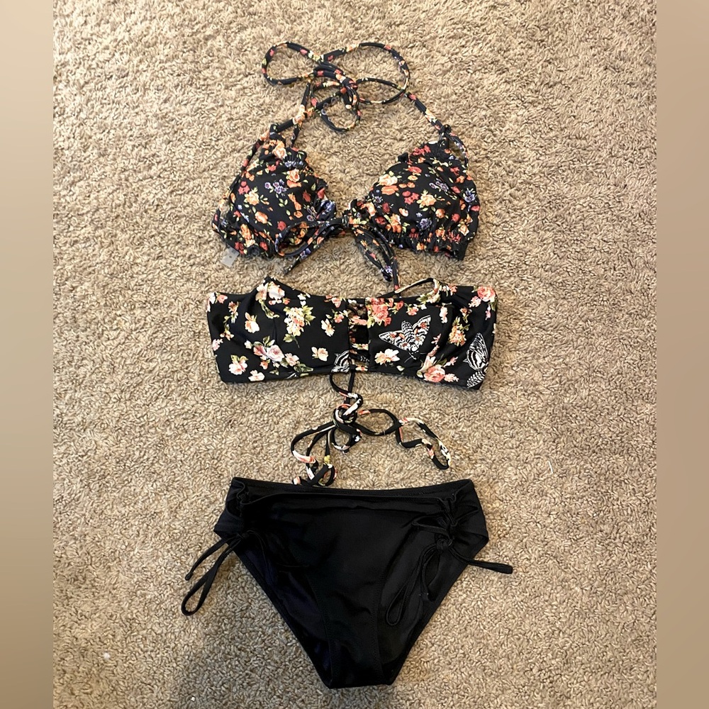 Two swimsuit tops and a pair of bottoms